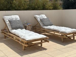 two lounge chairs sitting next to each other on a patio at Alto Mar Apartment in Peniche