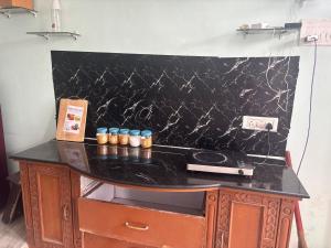 a counter with a black counter top with candles on it at Lara Homestay duplex 1bhk in Secunderabad +18 photos