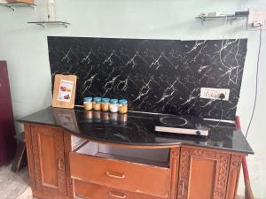 a black counter with candles on top of it at Lara Homestay duplex 1bhk in Secunderabad