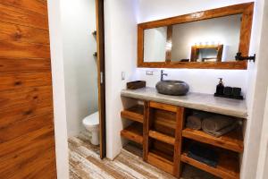 a bathroom with a sink and a mirror at Casa Swell Coronado, Adults-Only Boutique Hotel, Pool & Beach in Playa Coronado