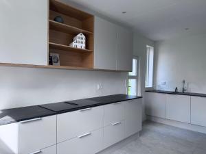 a kitchen with white cabinets and a counter top at Tønder Byhus in Tønder