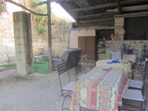 a patio with tables and chairs in a building at Chez Annie Chambre chez l'habitant in Distré