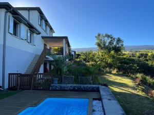 a house with a swimming pool next to a house at Villa Inelda in Saint-Paul