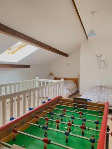 a room with a pool table in the middle at Le Bellevue in Xonrupt-Longemer