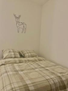 a bedroom with a bed with a deer on the wall at Le Bellevue in Xonrupt-Longemer