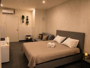 a bedroom with a bed with two towels on it at Wellness Suite Zeist in Zeist
