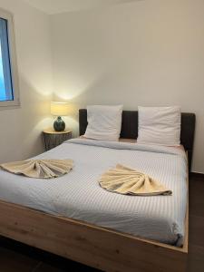 a bedroom with a bed with two towels on it at Villa Inelda in Saint-Paul +18 photos