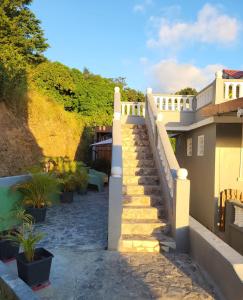 a staircase leading up to a house with plants at portsmouth Cottage Haven Escapes in Portsmouth