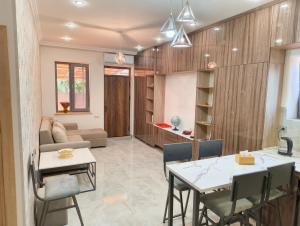a dining room and living room with a table and chairs at T'teni in Urtsʼadzor