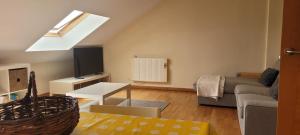 a living room with a couch and a tv at Atico en Carnota para 4 personas in Vilar