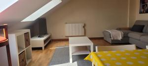 a small living room with a couch and a tv at Atico en Carnota para 4 personas in Vilar