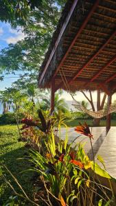 a porch of a resort with a hammock and plants at Belamandy Lodge Hotel au luxe simple in Anjramarango