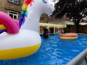 a group of people playing in a pool with a inflatable duck at Livry Gargan in Livry-Gargan