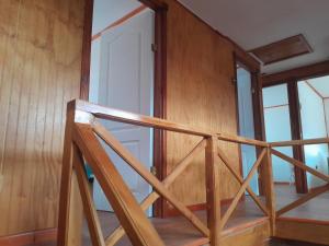 a wooden staircase in a room with wooden walls at Isidora in Puerto Aisén