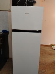 a white refrigerator freezer sitting in a kitchen at Tamari in Ureki