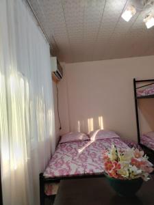 a bedroom with a bed with flowers on it at Tamari in Ureki