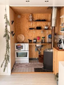 a kitchen with a stove and a sink at Tiny house at Enhrna in Enhörna