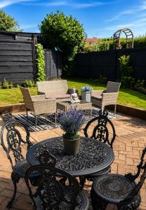 a patio with chairs and a table and a table and chairs at That's Amore House 3 bedroom house with parking walking distance to Sandbach town in Sandbach