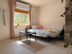 a small bedroom with a bed and a table at Tiny house at Enhrna in Enhörna