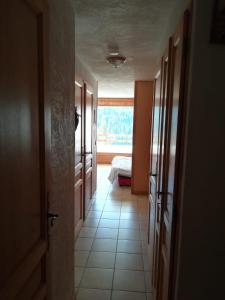 a hallway with a room with a bed and a window at Nice relax chalet ski m o d e r n in Arâches-la-Frasse