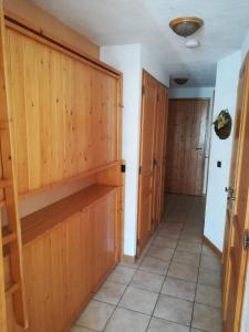 a hallway with wooden doors and a tile floor at Nice relax chalet ski m o d e r n in Arâches-la-Frasse