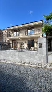 a building with a balcony on the side of a street at Rubin Boutique in Korçë