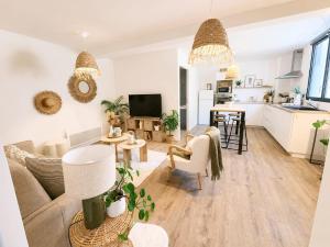 a living room with a couch and a table at Appartement cosy Beaupréau centre in Beaupréau