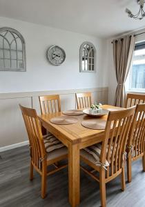 a dining room with a wooden table and chairs at That's Amore House 3 bedroom house with parking walking distance to Sandbach town in Sandbach