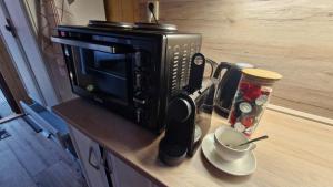 a microwave sitting on a counter with a cup of coffee at Chata Veverka in Doksy