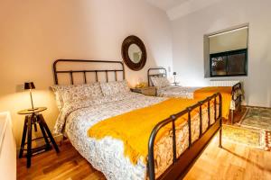 a bedroom with two beds and a mirror on the wall at The Tailor's Cottage in Lahinch +53 photos