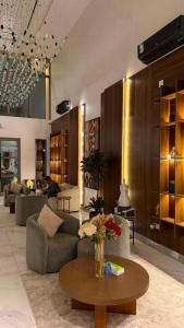 a living room with couches and a coffee table at فندق لوسكا in Abha