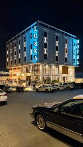 a building with cars parked in front of it at فندق لوسكا in Abha