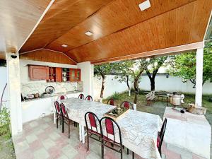 a patio with a table and chairs and a kitchen at Gabala Grean Villa in Gabala
