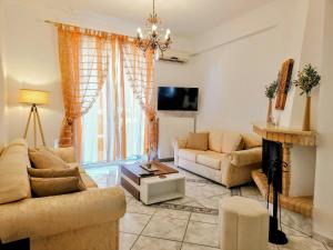 a living room with two couches and a fireplace at Akrata Maisonette in Akrata