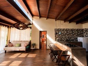 a living room with a table and a couch at Jardim Mirim in Cananéia