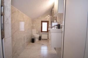 a bathroom with a toilet and a sink at Monte Vista in Bansko +32 photos
