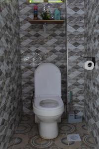 a bathroom with a white toilet in a room at Kilimavista Homes studio D2 in Kimana +14 photos