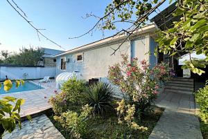 a house with a patio and a swimming pool at Gabala Grean Villa in Gabala
