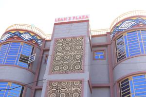 a building with a sign on the side of it at Kilimavista Homes studio D2 in Kimana