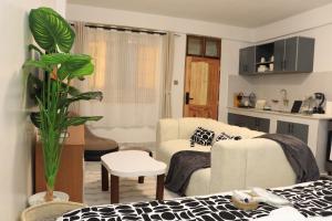 a living room with a bed and a couch at Kilimavista Homes studio D2 in Kimana