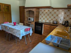 a kitchen with a table and a kitchen with a sink at Le Petiou Landais in Soustons