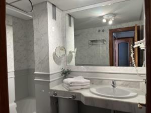 a bathroom with a sink and a large mirror at Ocean Dream Apartment in Playa Jandia +29 photos