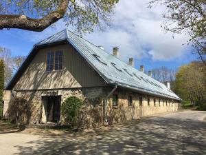 an old stone building with a metal roof at Harmoonikum in Viimsi