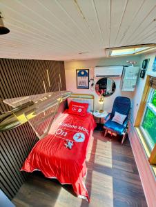 a bedroom with a bed and a chair in it at World Solo Travel's Welcomed At St Pete Home in St. Petersburg