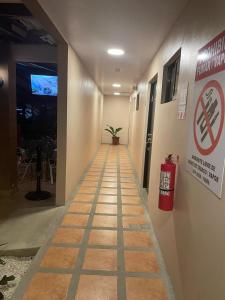 a hallway with a no smoking sign in a building at Hotel La Punta in Puntarenas