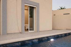 an external view of a house with a swimming pool at Villas avec piscine in Taguermess
