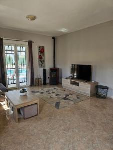 a living room with a tv and a coffee table at Villa - Sleeps 4 - Pool - Patio - Parking in Arboleas