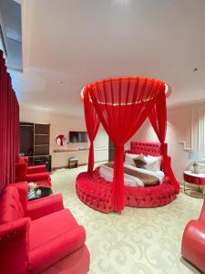 a bedroom with a bed with a red canopy at Grand Hotel & Spa Bac Ninh in Ðồng Ky +12 photos