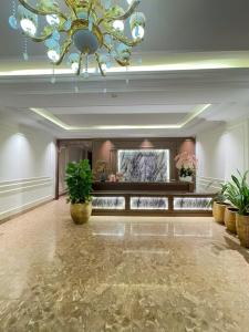 a large lobby with a chandelier and plants in it at Grand Hotel & Spa Bac Ninh in Ðồng Ky