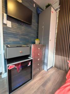 a living room with a tv on a wall at World Solo Travel's Welcomed At St Pete Home in St. Petersburg